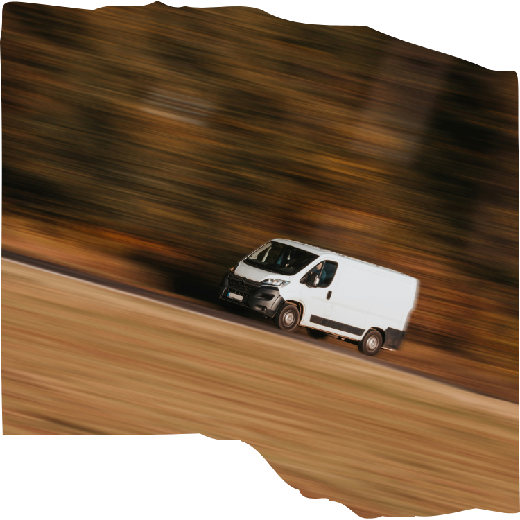 white van travelling along road